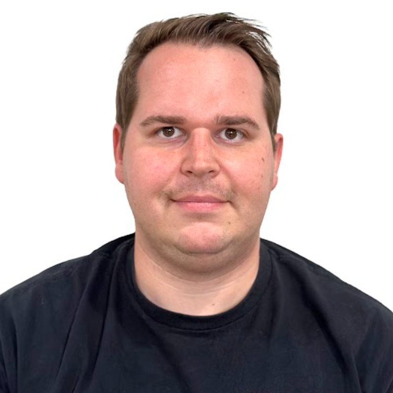 A man with short hair and glasses wearing a black shirt.